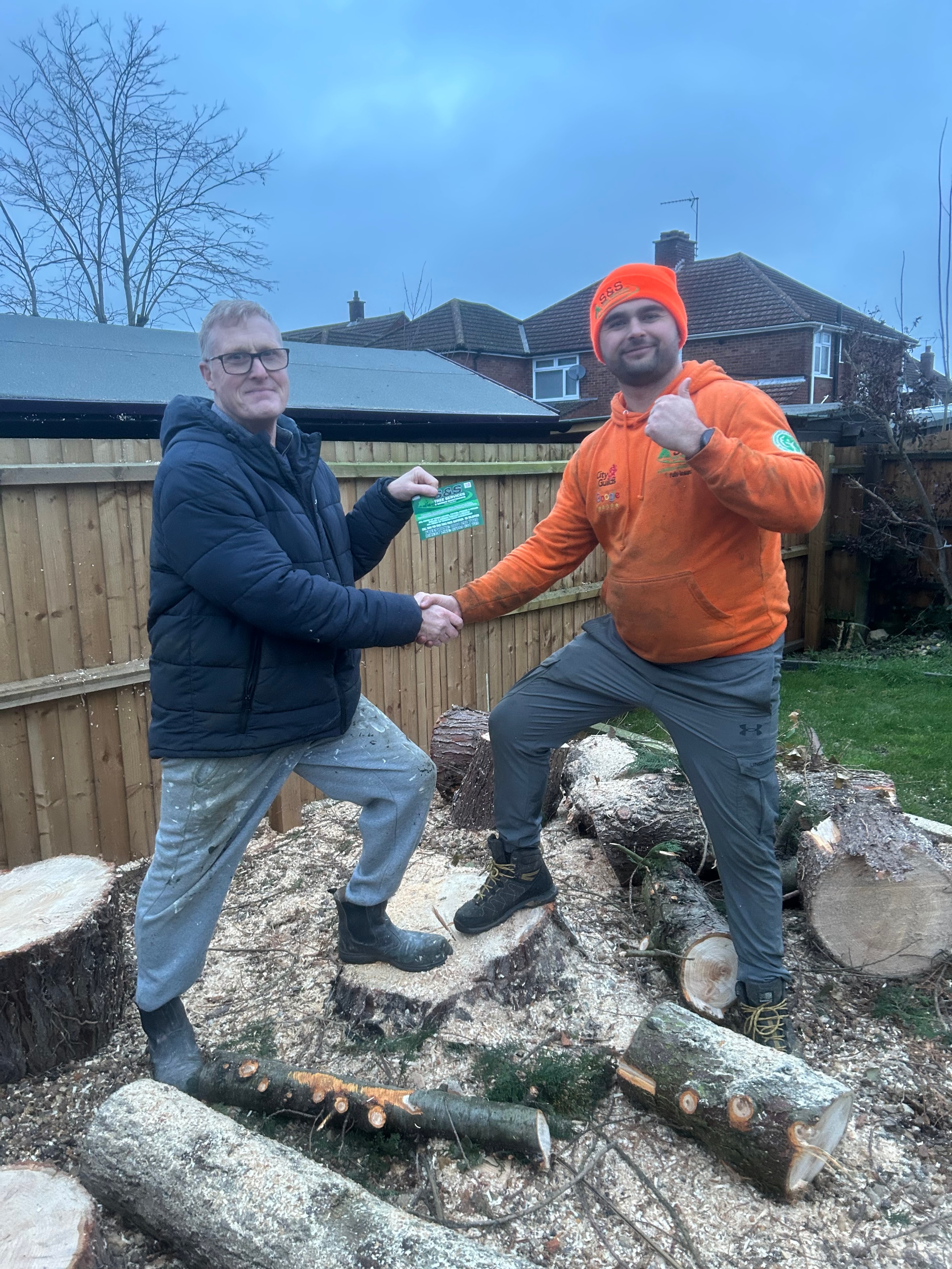Emmanuel from S&S Tree Services with a happy customer after completing the job