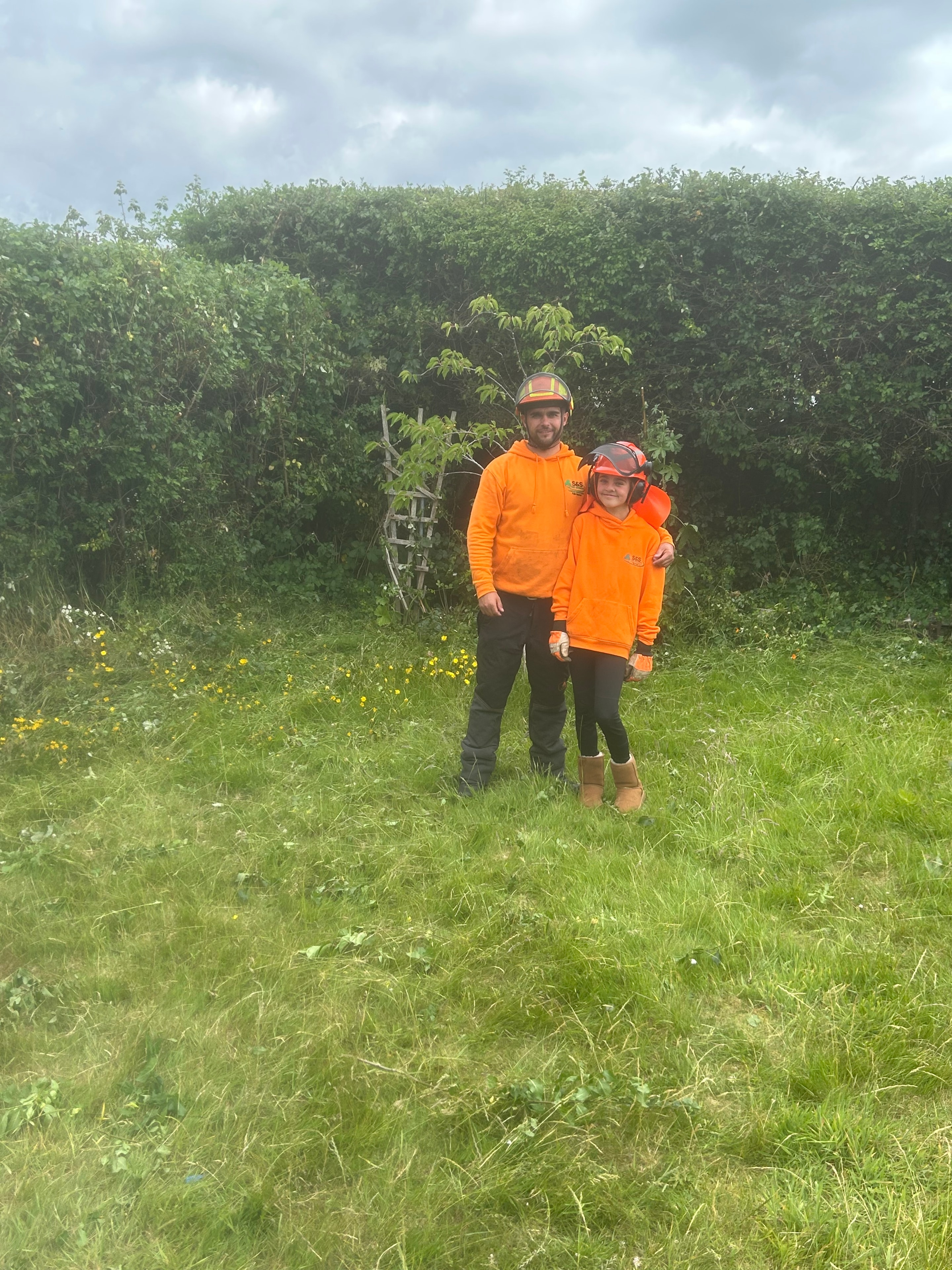 S&S Tree Services team with a happy customer after a successful job